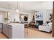 Open floor plan showcases living room with fireplace open to the modern kitchen design at 3248 Shirecrest Ln, Dacula, GA 30019