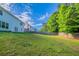 A large backyard with wood fence, green trees and grass at 3460 Village Park Sw Ln, Atlanta, GA 30331