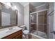 Well-lit bathroom featuring a glass door shower and wooden vanity at 3460 Village Park Sw Ln, Atlanta, GA 30331