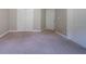Neutral bedroom featuring double doors to a closet, carpet, and neutral paint at 3460 Village Park Sw Ln, Atlanta, GA 30331