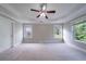 Large primary bedroom with tray ceiling, carpet, and lots of natural light at 3460 Village Park Sw Ln, Atlanta, GA 30331