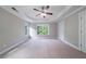 Spacious bedroom featuring tray ceiling, neutral paint, carpet, and natural light at 3460 Village Park Sw Ln, Atlanta, GA 30331
