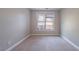 A Bedroom featuring carpet, one window with blinds, neutral colors, and painted baseboards at 3460 Village Park Sw Ln, Atlanta, GA 30331