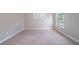 An empty bedroom has neutral paint and carpet at 3460 Village Park Sw Ln, Atlanta, GA 30331