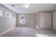 An empty carpeted bedroom with natural light from the windows and an adjacent closet at 3460 Village Park Sw Ln, Atlanta, GA 30331
