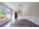 An empty Dining Room featuring hardwood flooring, wainscotting, and a view to the backyard at 3460 Village Park Sw Ln, Atlanta, GA 30331