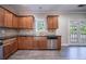 Kitchen area with stainless appliances, wood cabinets, and granite countertops near dining at 3460 Village Park Sw Ln, Atlanta, GA 30331
