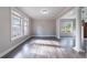An empty Living Room with hardwood flooring featuring plenty of natural light from surrounding windows at 3460 Village Park Sw Ln, Atlanta, GA 30331