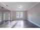 An empty Living Room with hardwood flooring that is well lit by the natural light entering through windows at 3460 Village Park Sw Ln, Atlanta, GA 30331