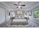 This main bedroom features tray ceilings, a ceiling fan, and lots of natural light at 3460 Village Park Sw Ln, Atlanta, GA 30331