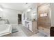 A luxurious bathroom featuring a soaking tub, granite countertops, and a glass-enclosed shower at 2410 Bridle Bridge Trl, Cumming, GA 30040