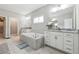 Bathroom features dual vanities, soaking tub, and modern fixtures at 2410 Bridle Bridge Trl, Cumming, GA 30040
