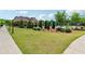 Expansive community lawn with lush green grass and well-manicured landscaping near the swimming pool and clubhouse at 2410 Bridle Bridge Trl, Cumming, GA 30040