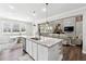 Gourmet kitchen with granite island, dining area and flows into the living room creating an open concept at 2410 Bridle Bridge Trl, Cumming, GA 30040