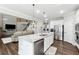 Contemporary kitchen with large island, stainless steel appliances and open concept living space at 2410 Bridle Bridge Trl, Cumming, GA 30040