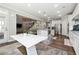 Open concept kitchen and dining area with stainless steel appliances and a seamless connection to living area at 2410 Bridle Bridge Trl, Cumming, GA 30040