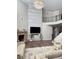 Living room showcasing high ceilings, marble fireplace, mounted television and a staircase to second level at 2410 Bridle Bridge Trl, Cumming, GA 30040