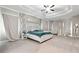 Expansive main bedroom featuring tray ceilings, ample lighting, and neutral tones at 2410 Bridle Bridge Trl, Cumming, GA 30040