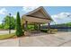Open-air community pavilion with picnic tables and seating, perfect for social gatherings near the tennis court at 2410 Bridle Bridge Trl, Cumming, GA 30040