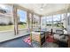 A sunroom with large windows offering panoramic views and comfortable seating at 2410 Bridle Bridge Trl, Cumming, GA 30040