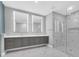 Modern bathroom featuring a double vanity, sleek countertops, and a glass-enclosed shower with elegant marble accents at 2520 Peachtree Nw Rd # 403, Atlanta, GA 30305