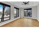 An airy bedroom with hardwood floors, large windows, and a ceiling fan, showcasing an urban view at 2520 Peachtree Nw Rd # 403, Atlanta, GA 30305