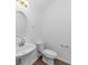 Bathroom featuring a white sink and toilet with a large oval mirror at 2530 Marlin Dr, Mcdonough, GA 30253