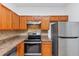 Well-equipped kitchen with stainless steel appliances and warm wood cabinetry at 2530 Marlin Dr, Mcdonough, GA 30253