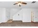 Spacious living room featuring new carpet, a ceiling fan and entry to stairs at 2530 Marlin Dr, Mcdonough, GA 30253