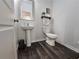 Simple bathroom with pedestal sink, toilet, and mirror. Neutral color scheme creates a calming space at 261 Mahone Dr, Lilburn, GA 30047