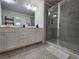 Bathroom featuring a glass enclosed shower, double vanity, and tile flooring at 261 Mahone Dr, Lilburn, GA 30047
