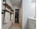 Bathroom featuring wooden shelves, white cabinets, and light tile flooring at 261 Mahone Dr, Lilburn, GA 30047