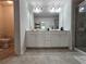 Bathroom featuring double vanity, large mirror, tile floor and glass-enclosed shower at 261 Mahone Dr, Lilburn, GA 30047