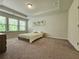Spacious bedroom featuring neutral carpet, tray ceiling, and bright windows at 261 Mahone Dr, Lilburn, GA 30047