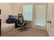 Carpeted room with bed, chair, desk, and natural light from a window and door at 261 Mahone Dr, Lilburn, GA 30047
