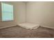 Clean, carpeted bedroom with natural light from a window and neutral color at 261 Mahone Dr, Lilburn, GA 30047