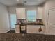 Well-lit kitchen featuring granite countertops, stainless steel appliances, and ample cabinet space at 261 Mahone Dr, Lilburn, GA 30047