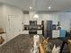 Kitchen with granite countertops, stainless steel appliances, and wood flooring at 261 Mahone Dr, Lilburn, GA 30047