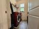 Practical laundry room with modern washer and dryer, shelving, and a window at 261 Mahone Dr, Lilburn, GA 30047