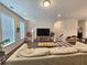 Comfortable living room with a large couch, hardwood floors, and natural light at 261 Mahone Dr, Lilburn, GA 30047