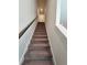 Carpeted staircase leading up to a white door with wooden handrail at 261 Mahone Dr, Lilburn, GA 30047