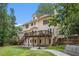 This home offers an expansive backyard with a deck, a patio, and mature landscaping at 300 Wesfork Nw Way, Suwanee, GA 30024