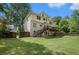 Large backyard with a deck and stairs on the rear of the home at 300 Wesfork Nw Way, Suwanee, GA 30024