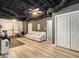 Finished basement with exposed ceiling, painted dark, with full gym and living room area at 300 Wesfork Nw Way, Suwanee, GA 30024