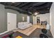 Finished basement with exposed ceiling, laminate flooring, gym equipment, and comfortable seating at 300 Wesfork Nw Way, Suwanee, GA 30024