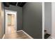 Hallway leading into finished basement features wood flooring, and dark paint at 300 Wesfork Nw Way, Suwanee, GA 30024