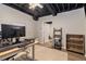 Finished basement with desk and office space, laminate flooring, and exposed ceiling at 300 Wesfork Nw Way, Suwanee, GA 30024