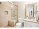 Well-lit bathroom featuring a tiled shower with a glass door and a modern vanity at 300 Wesfork Nw Way, Suwanee, GA 30024