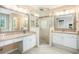Elegant bathroom featuring dual sinks, granite countertops, decorative mirrors, and a tiled glass shower at 300 Wesfork Nw Way, Suwanee, GA 30024