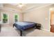 Spacious bedroom with a tray ceiling, plush carpet, and dual windows providing ample natural light at 300 Wesfork Nw Way, Suwanee, GA 30024